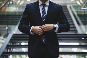 business man securing suit in front of staircase